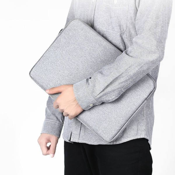 man holding laptop sleeve